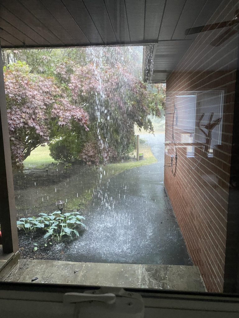 Water overflowing a gutter. Issues with clogged gutters is a common inspection issue. 