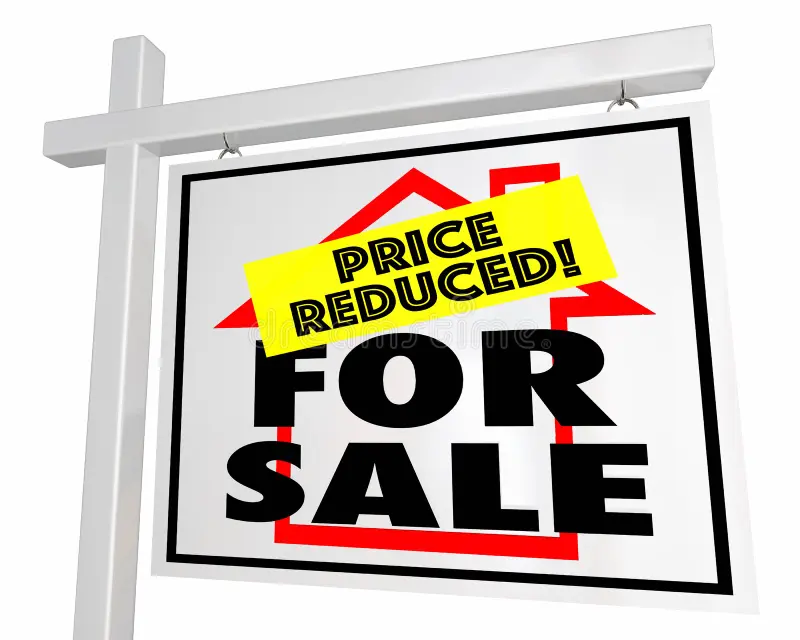 Real estate sign showing for sale with a price reduced tag